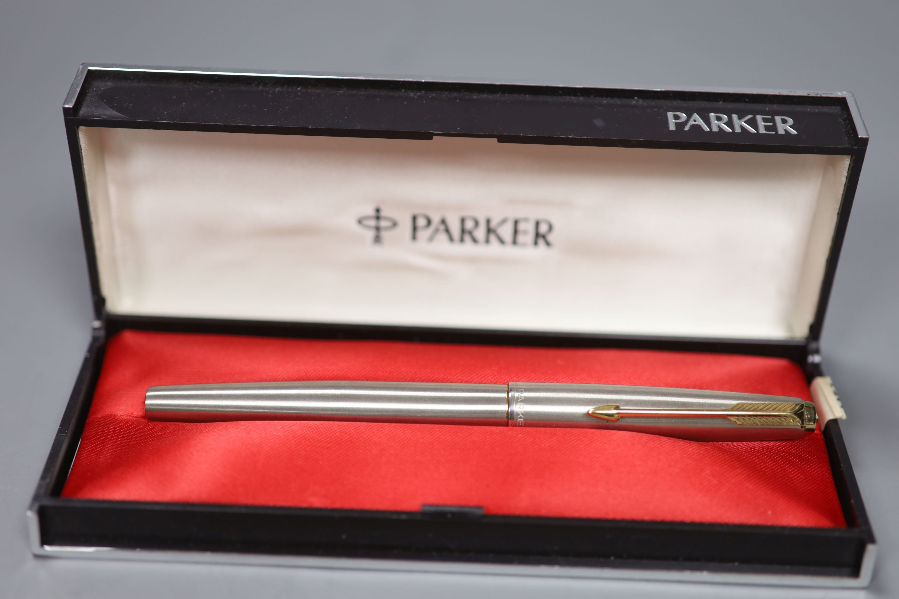 A collection of fountain pens and pencils including a brushed steel Parker 61,